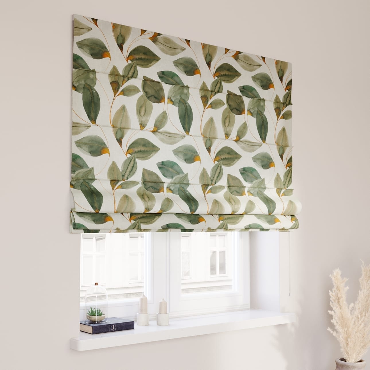 Roman blinds with a green leafy botanical pattern covering a window in a light-colored room